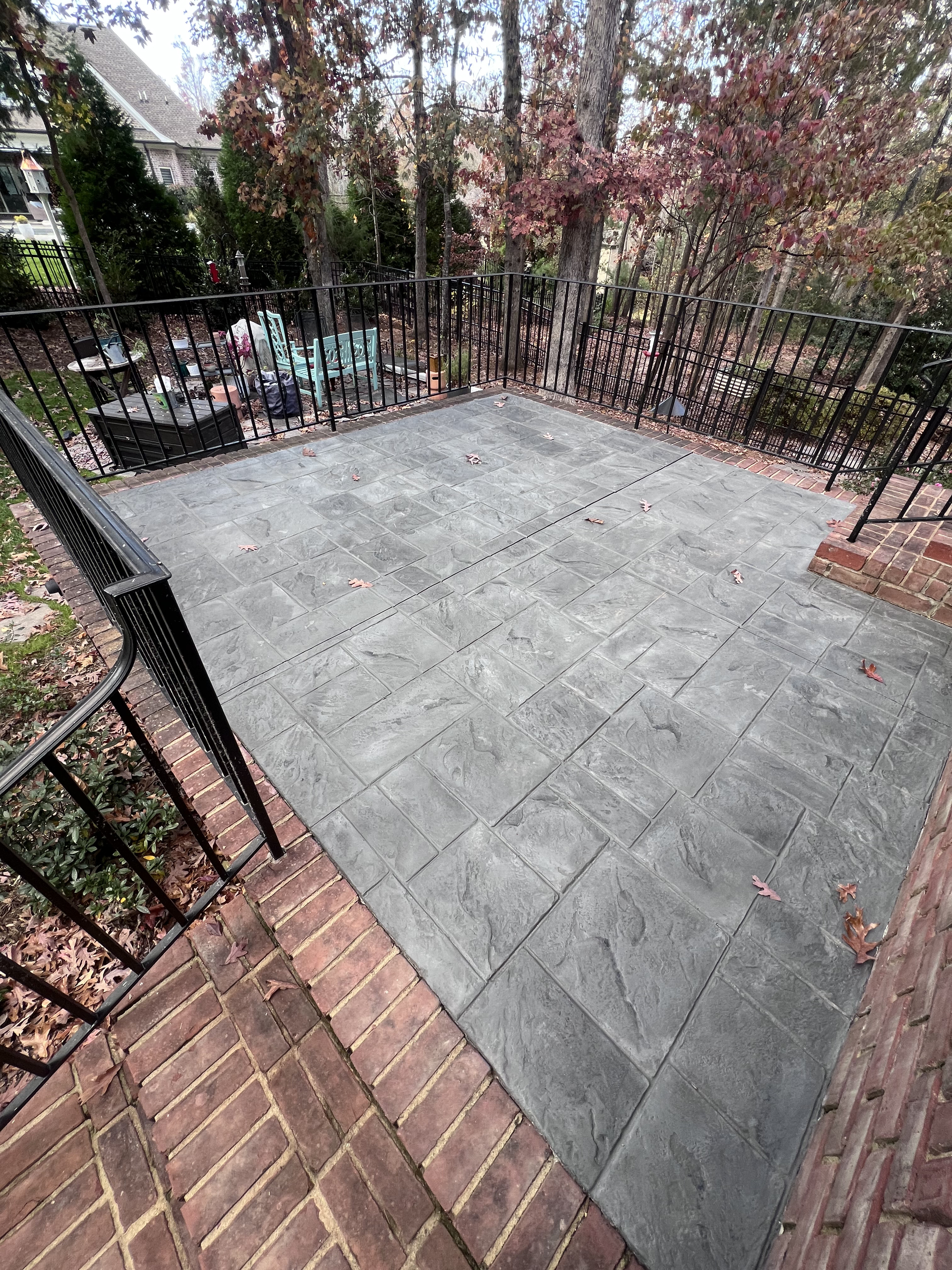 Backarea with decorative concrete patio and handcrafted finish
