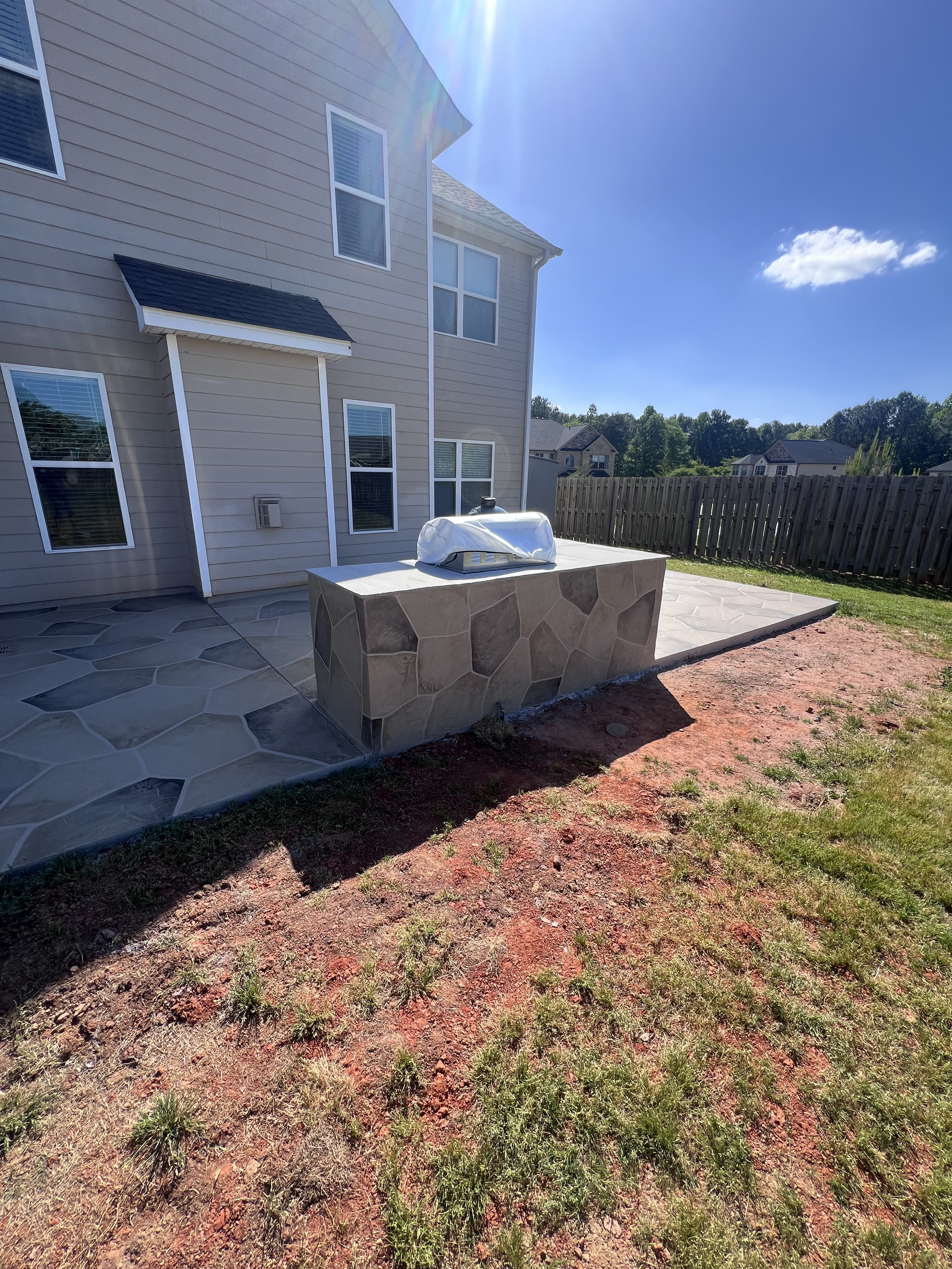 Backarea with decorative concrete patio and handcrafted finish